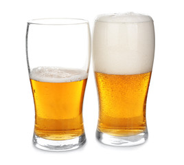 Full and half-filled glasses of cold beer on white background