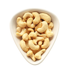 Bowl with tasty cashew nuts on white background