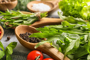 Fresh herbs with spices on wooden table