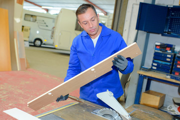 worker looking at wood
