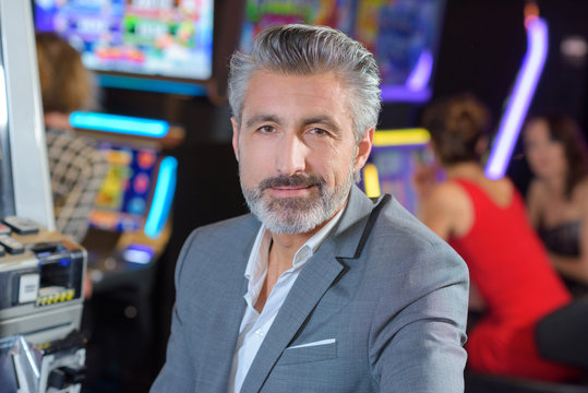 handsome young man with slot machine in the casino