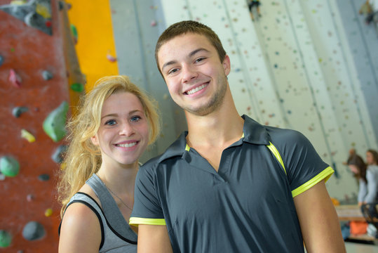 young couple giving high five in a climbing gym