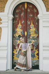 Obraz premium Cute Thai girl wearing thai traditional clothing. She posing traditional dancing.