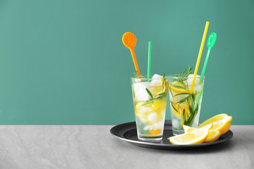 Tasty lemonade with rosemary in glasses on table