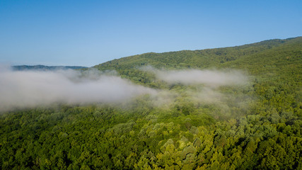 4K Epic Aerial Flight Through Mountain Clouds on Sunrise Beautiful Morning. Peaks Inspirational Motivational Nature Background.