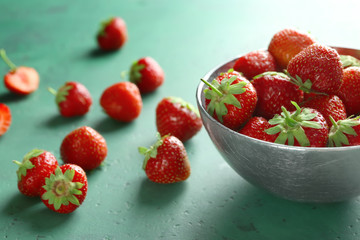 Bowl with sweet ripe strawberries on table
