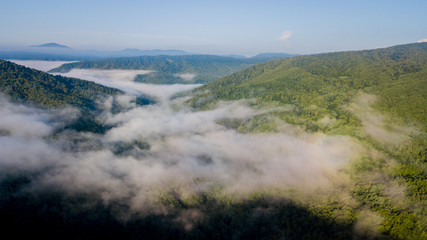 4K Epic Aerial Flight Through Mountain Clouds on Sunrise Beautiful Morning. Peaks Inspirational Motivational Nature Background.