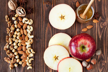 Sliced red apples, honey, nuts