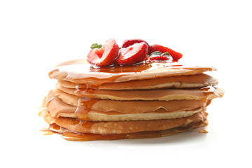 Delicious pancakes with honey and strawberries on white background