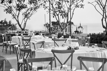 Wedding reception dinner table setting with folding lawn chairs in Black and White