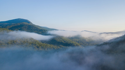 Fototapeta na wymiar Epic Aerial Flight Through Mountain Clouds. Sunrise Beautiful Morning.