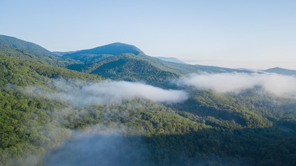 Epic Aerial Flight Through Mountain Clouds. Sunrise Beautiful Morning.