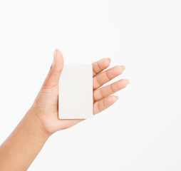 Obraz premium hand hold blank business card. female arm hold paper isolated on white background. copy space. mock up.