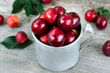 Cup with ripe plum.