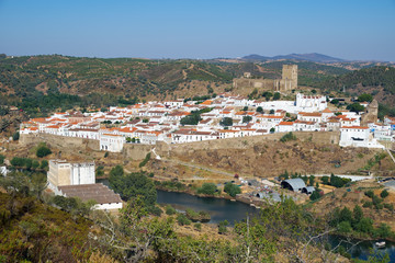 Fototapeta na wymiar Mertola town as seen from the high opposite riverside of the Guadiana. Portugal
