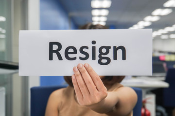 close up businesswoman hold resignation paper in office to quit the job