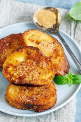 Slices of fried baguette in the egg and mint leaves.