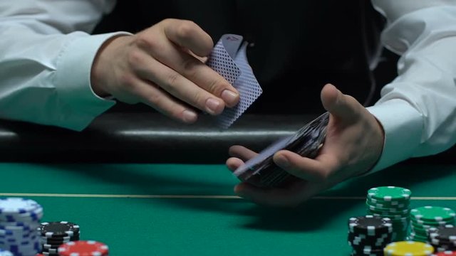 Experienced casino croupier showing diamond ace, winning opportunities, luck