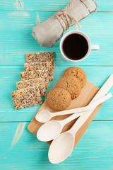 Cup of hot coffee assorted with cookies for breakfast on wooden vintage table.
