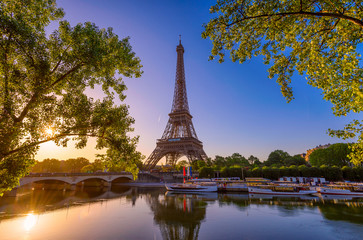 Naklejka na ściany i meble View of Eiffel Tower and river Seine at sunrise in Paris, France. Eiffel Tower is one of the most iconic landmarks of Paris