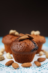 Delicious homemade chocolate muffins on the blue vintage wooden background.