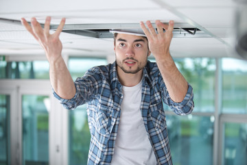 builder replacing ceiling panel