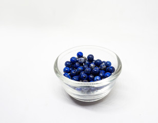 natural lapis lazuli in Glass cup on white background