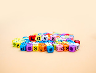 Love : Colorful cube letters on orange Background
