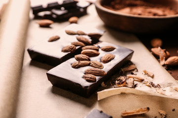 Delicious chocolate with almonds on parchment