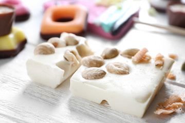 Pieces of white chocolate on wooden table