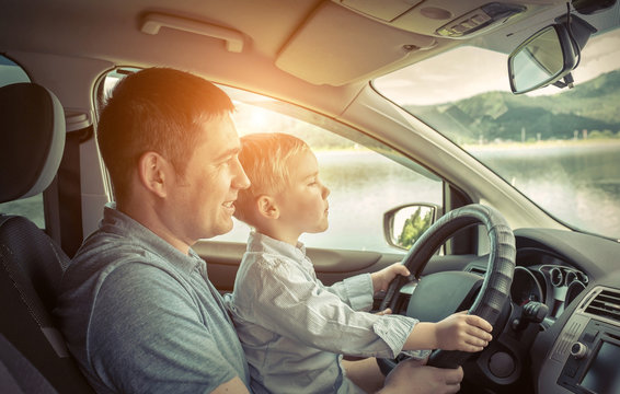 Father and son driving in car