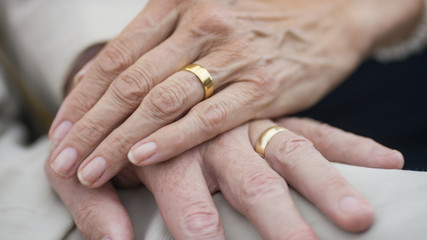 Portrait of older senior hands with wedding rings on  - obrazy, fototapety, plakaty