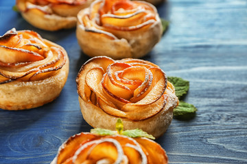 Tasty rose shaped apple pastry on wooden table