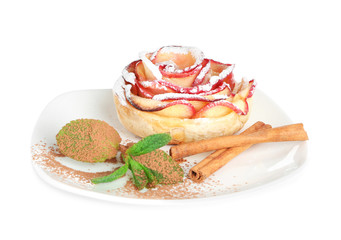 Plate with tasty rose shaped apple pastry on white background