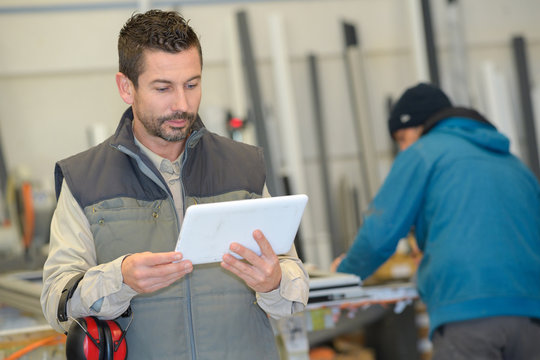 worker looking at digital tablet in warehouse