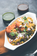 Ragda Pattice is a popular Street food or chat made of potato Patties. served in a steel plate, bowl or ceramic plate with tamarind and cilantro chutney