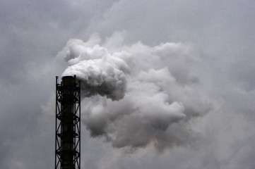 smoking industrial pipe on gray sky