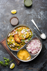 Ragda Pattice is a popular Street food or chat made of potato Patties. served in a steel plate, bowl or ceramic plate with tamarind and cilantro chutney