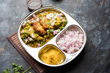 Ragda Pattice is a popular Street food or chat made of potato Patties. served in a steel plate, bowl or ceramic plate with tamarind and cilantro chutney