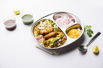 Ragda Pattice is a popular Street food or chat made of potato Patties. served in a steel plate, bowl or ceramic plate with tamarind and cilantro chutney