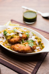Ragda Pattice is a popular Street food or chat made of potato Patties. served in a steel plate, bowl or ceramic plate with tamarind and cilantro chutney