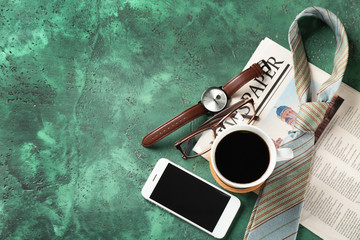 Naklejka premium Composition with smartphone, cup of coffee and male accessories on color textured background. Happy Father's Day celebration