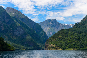 Fototapeta na wymiar Magnificent fjord landscape with a trace from the boat. Neroyfjord offshoot of Sognefjord is the narrowest fjord in Europe. Norway.