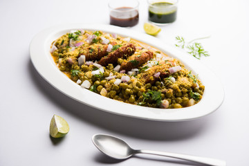 Ragda Pattice is a popular Street food or chat made of potato Patties. served in a steel plate, bowl or ceramic plate with tamarind and cilantro chutney