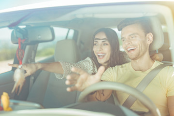 New city. Happy beaming couple feeling unbelievably excited while traveling to new city together