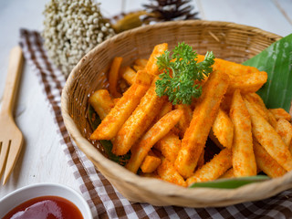 French fried barbeque flavour in wood basket on white wood table.