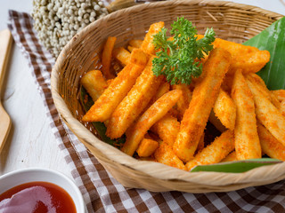French fried barbeque flavour in wood basket on white wood table.