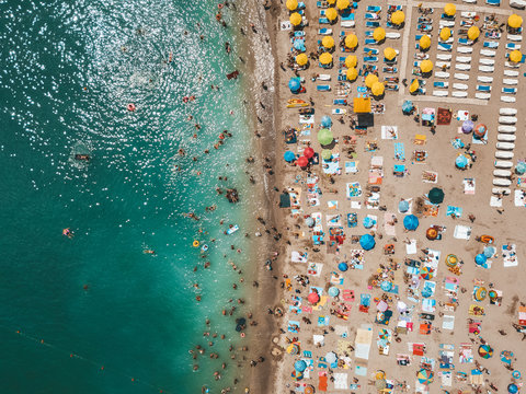 Aerial View From Flying Drone Of People Crowd Relaxing On Beach In Romania At The Black Sea