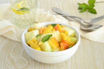 Salad with melon, corn and sweet pepper