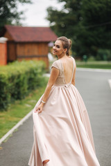 Young stylish model poses to photographer outside